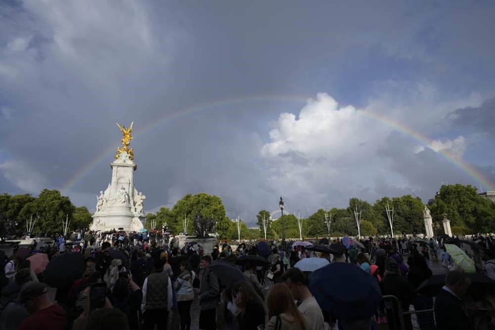 People gather outside Buckingham Palace in London, Thursday, Sept. 8, 2022. Buckingham Palace says Queen Elizabeth II has been placed under medical supervision because doctors are