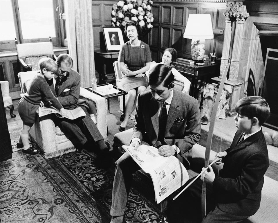FILE - In this previously unpublished 1969 file photo, one of a series specially taken to show the informal life of Prince Charles, Britain's Queen Elizabeth II, background centre and Prince Philip sit with their children Prince Edward, left, Princess Anne, background, Prince Charles, foreground and Prince Andrew, right at Sandringham House, in Sandringham, England. Queen Elizabeth II, Britain’s longest-reigning monarch and a rock of stability across much of a turbulent century, has died. She was 96. Buckingham Palace made the announcement in a statement on Thursday Sept. 8, 2022. (AP Photo, File)
