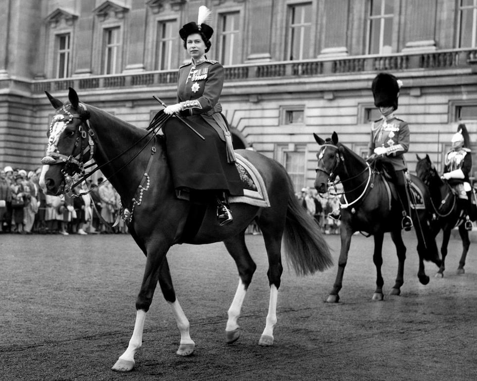 FILE This June 15, 1960 file photo shows Queen Elizabeth II, riding out from Buckingham Palace, London to take the salute at the ceremony of Trooping the Colour, followed by Prince Philip and with him is the Duke of Gloucester, the Queen's uncle. Queen Elizabeth II, Britain’s longest-reigning monarch and a rock of stability across much of a turbulent century, has died. She was 96. Buckingham Palace made the announcement in a statement on Thursday Sept. 8, 2022. (AP Photo, File)