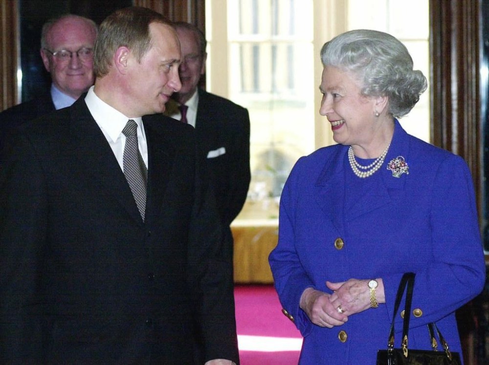 FILE - In this Monday, April 17, 2000 file photo, Britain's Queen Elizabeth II, right talks with Russian President Vladimir Putin, prior to a private audience at Windsor Castle, on his first visit to the West as Russian President, in Windsor, England. Queen Elizabeth II, Britain’s longest-reigning monarch and a rock of stability across much of a turbulent century, has died. She was 96. Buckingham Palace made the announcement in a statement on Thursday Sept. 8, 2022. (Fiona Hanson/Pool Photo via AP, File)