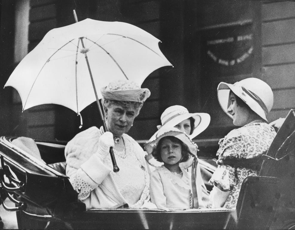 FILE - Britain's Queen Mary, left, rides in her carriage with Princess Elizabeth and Queen Elizabeth, right, after the trooping the colour ceremony in honour of king George V 68th Birthday, in London, June 3rd, 1933. The queen was christened Elizabeth Alexandra Mary of York, in honor of her mother, paternal grandmother and paternal great-grandmother. But as a child, she was endearingly known as young Lilibet by her family said to be because she couldn’t pronounce Elizabeth properly. (AP Photo, File)