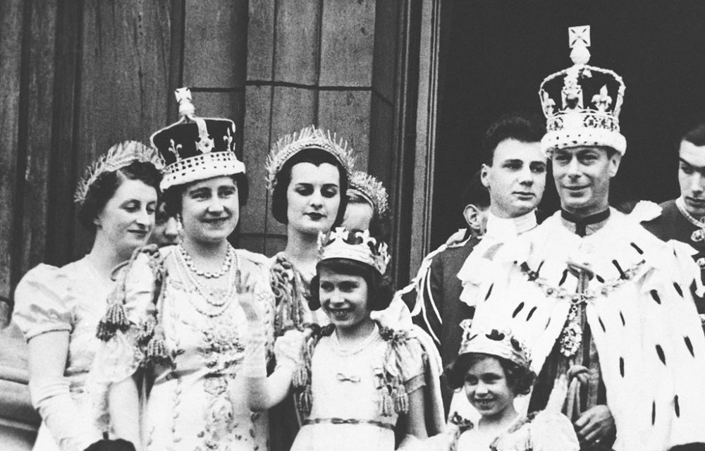 FILE - In this May 12, 1937 file photo, Britain's Princess Elizabeth and Princess Margaret appear on the balcony of Buckingham Palace, on the day of the coronation of their father, King George VI, in London. Queen Elizabeth is at left. Queen Elizabeth II, Britain’s longest-reigning monarch and a rock of stability across much of a turbulent century, has died. She was 96. Buckingham Palace made the announcement in a statement on Thursday Sept. 8, 2022. (AP Photo, File)