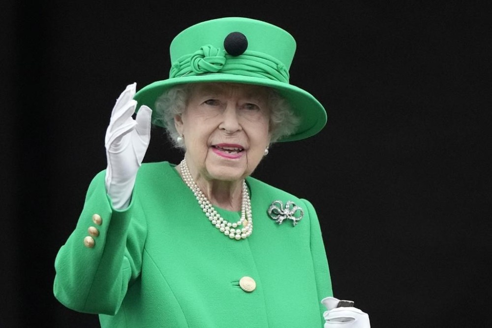 Queen Elizabeth II waves to the crowd during the Platinum Jubilee Pageant at the Buckingham Palace in London, Sunday, June 5, 2022.THE CANADIAN PRESS/AP-Frank Augstein, Pool
