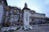 Flowers, flags, candles and messages are put at the gates of Buckingham Palace in London, Friday, Sept. 9, 2022. Queen Elizabeth II, Britain's longest-reigning monarch and a rock of stability across much of a turbulent century, died Thursday Sept. 8, 2022, after 70 years on the throne. She was 96. (AP Photo/Kirsty Wigglesworth)