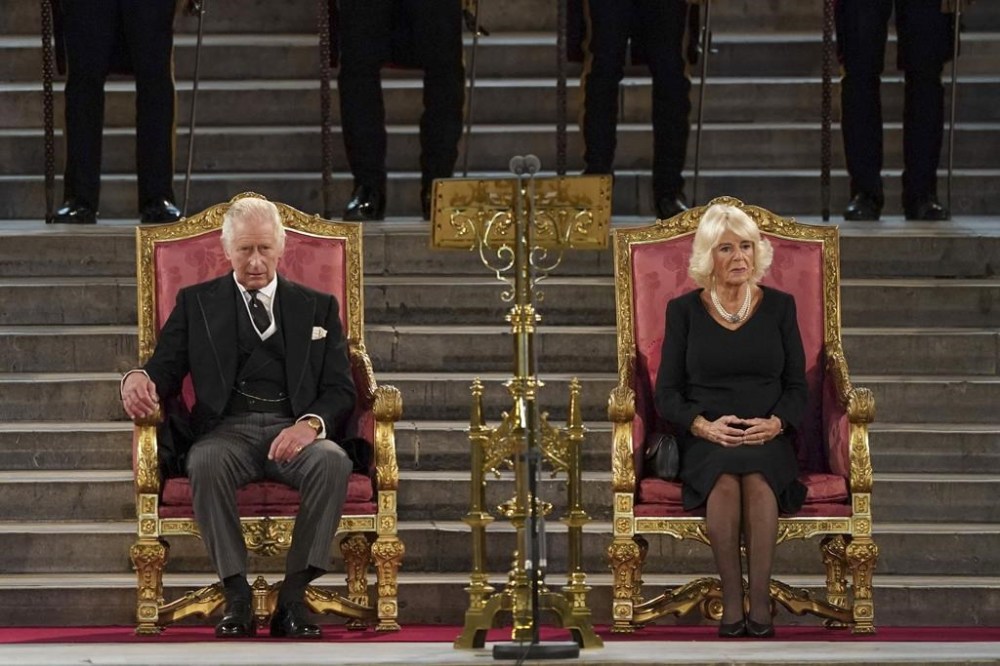 Britain's King Charles III, left, and the Queen Consort sit at Westminster Hall, where both Houses of Parliament are meeting to express their condolences following the death of Queen Elizabeth II, at Westminster Hall, in London, Monday, Sept. 12, 2022. Queen Elizabeth II, Britain's longest-reigning monarch, died Thursday after 70 years on the throne. (Stefan Rousseau/Pool Photo via AP)