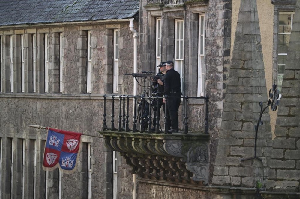 Police monitor the Royal Mile before the coffin of Queen Elizabeth II is transported to St Giles' Cathedral in Edinburgh, Monday, Sept. 12, 2022, to enable people of Scotland to pay their last respects. Britain's longest-reigning monarch who was a rock of stability across much of a turbulent century, died Thursday Sept. 8, 2022, after 70 years on the throne. She was 96. (AP Photo/Scott Heppell)