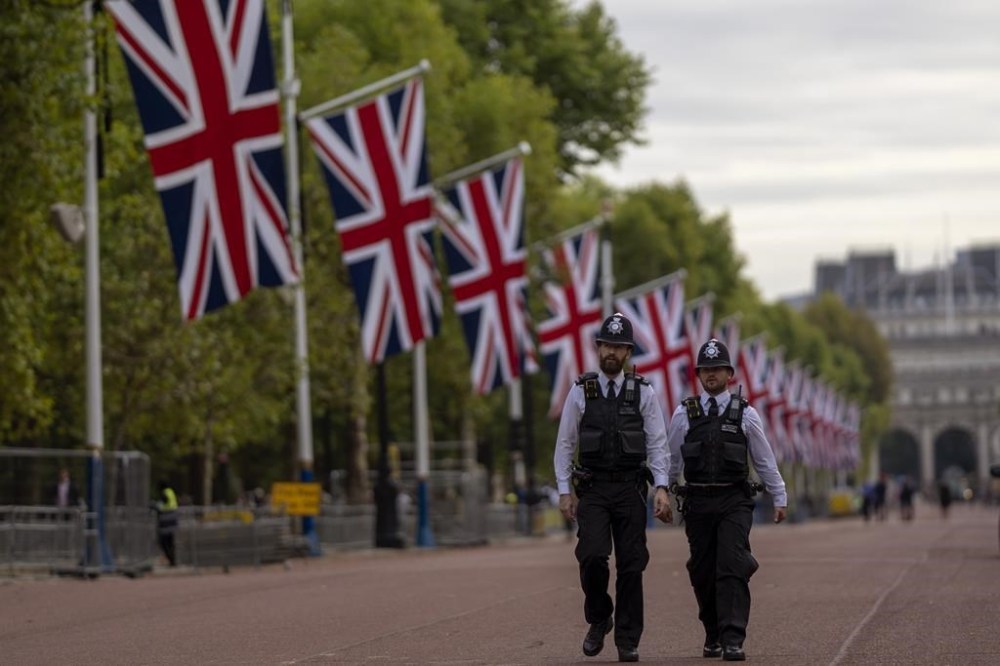 Police officers patrol near Buckingham Palace in London, Monday, Sept. 12, 2022. Queen Elizabeth II, Britain's longest-reigning monarch and a rock of stability across much of a turbulent century, died Thursday Sept. 8, 2022, after 70 years on the throne. She was 96. Queen Elizabeth II, Britain's longest-reigning monarch and a rock of stability across much of a turbulent century, died Thursday Sept. 8, 2022, after 70 years on the throne. She was 96. (AP Photo/Emilio Morenatti)