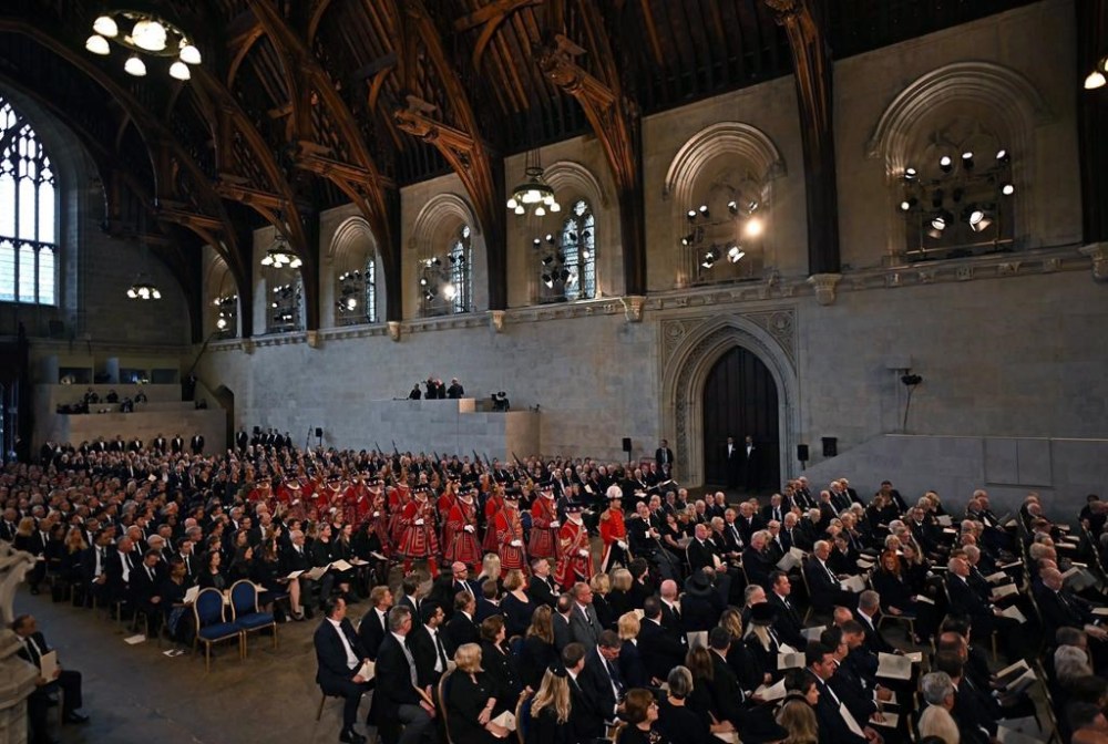 The King's Body Guard of the Yeomen of the Guard walk, ahead of the arrival of King Charles III and the Queen Consort at Westminster Hall, where both Houses of Parliament met to express their condolences , following the death of Queen Elizabeth II, in London, Monday, Sept. 12, 2022. Queen Elizabeth II, Britain's longest-reigning monarch and a rock of stability across much of a turbulent century, died Thursday Sept. 8, 2022, after 70 years on the throne. She was 96. (Ben Stansall/Pool Photo via AP)