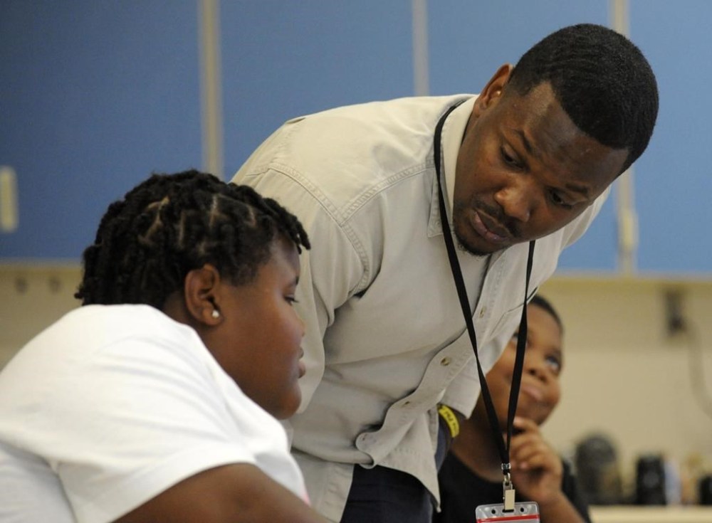 Timothy Allison, a collaborative special education teacher in Birmingham, Ala., works with a student at Sun Valley Elementary School on Thursday, Sept. 8, 2022. The school district is struggling to fill around 50 teaching spots, including 15 in special education, despite $10,000 signing bonuses for special education teachers. (AP Photo/Jay Reeves)