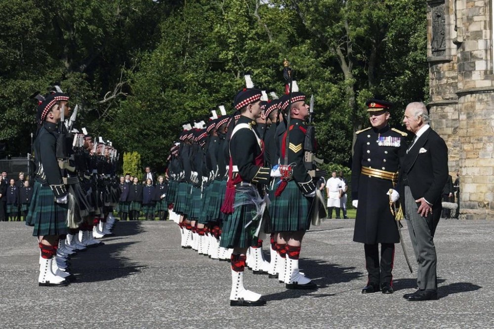 King Charles III inspects the Guard of Honour as he arrives to attend the Ceremony of the Keys, at the Palace of Holyroodhouse, Edinburgh, Monday, Sept. 12, 2022. King Charles arrived in Edinburgh on Monday to accompany his late mother’s coffin on an emotion-charged procession through the historic heart of the Scottish capital to a cathedral where it will lie for 24 hours to allow the public to pay their last respects. (Peter Byrne/Pool Photo via AP)