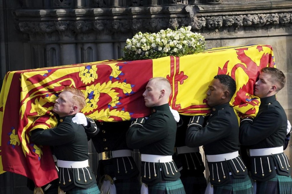 The coffin of Britain's Queen Elizabeth II is carried into St Giles' Cathedral, Edinburgh, Scotland, Monday Sept. 12, 2022. King Charles III arrived in Edinburgh on Monday to accompany his late mother’s coffin on an emotion-charged procession through the historic heart of the Scottish capital to the cathedral where it will lie for 24 hours to allow the public to pay their last respects. (Jacob King/Pool via AP)