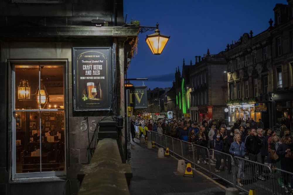 People queue to see the coffin of Queen Elizabeth II as she lies at rest at St Giles Cathedral in Edinburgh, Scotland, Monday, Sept. 12, 2022. Britain's longest-reigning monarch who was a rock of stability across much of a turbulent century, died Sept. 8, after 70 years on the throne. She was 96. (AP Photo/Bernat Armangue)