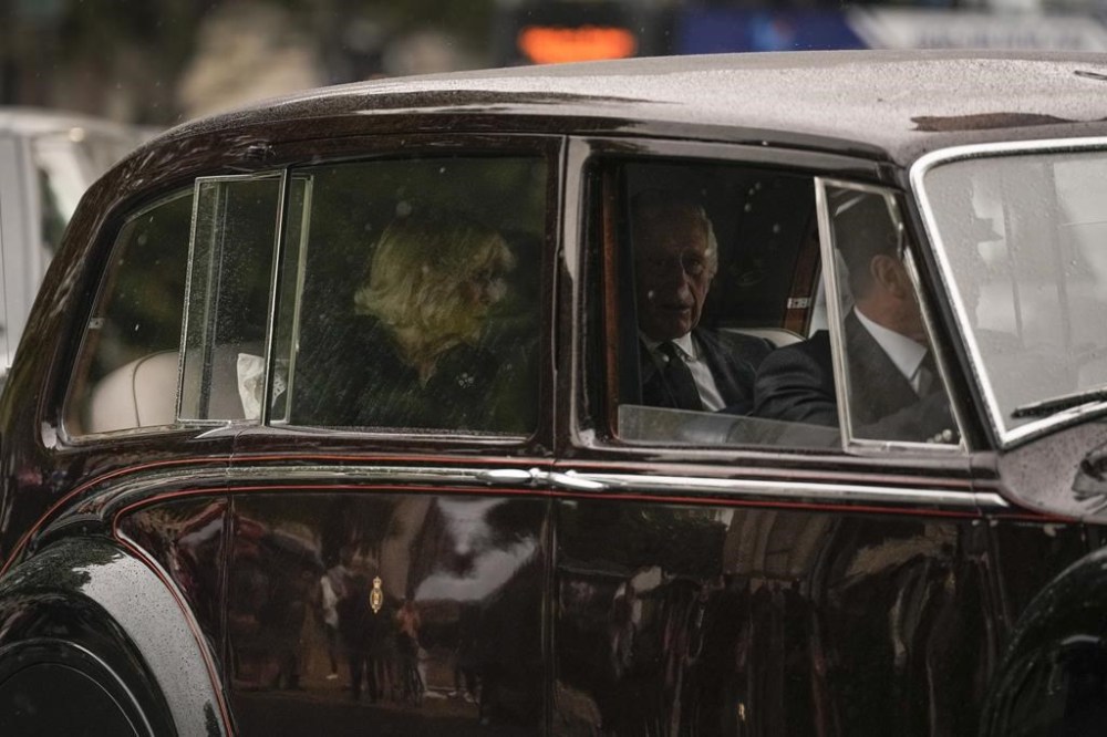 King Charles III and Camilla, the Queen Consort ride in a convoy carrying the coffin of late Queen Elizabeth II, as it heads towards Buckingham Palace in London, Tuesday, Sept. 13, 2022. Britain's longest-reigning monarch who was a rock of stability across much of a turbulent century, died Thursday Sept. 8, 2022, after 70 years on the throne. She was 96. (AP Photo/Andreea Alexandru)
