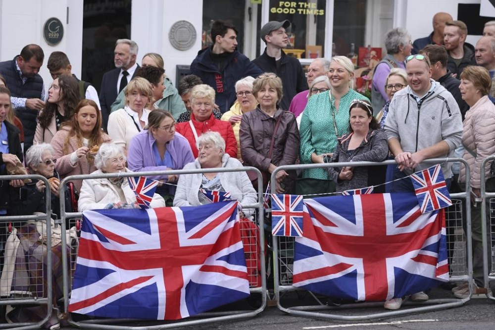 Large crowds gather to catch a glimpse of Britain's King Charles III and Queen Consort during their visit to Hillsborough Castle, Northern Ireland, Tuesday, Sept. 13, 2022. As King Charles III arrived in Northern Ireland for the first visit since his mother’s death elevated him to the throne, the voices of Belfast offered a sharp reminder of the country’s complicated bloody political realities. (AP Photo/Peter Morrison)