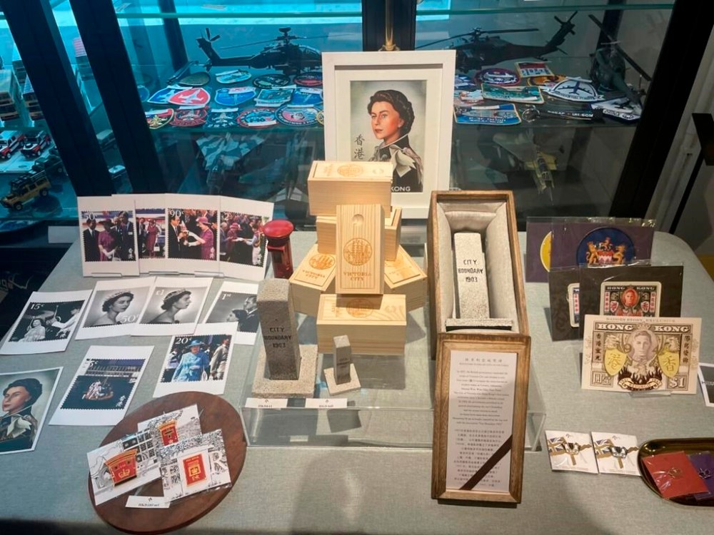 Postcards and various memorabilia, which are related to Queen Elizabeth II, are on display at souvenir shop House of Men, in Hong Kong, on Sept. 10, 2022. The shop saw renewed interests from visitors on the first weekend after the Queen's death. (AP Photo/Alice Fung)