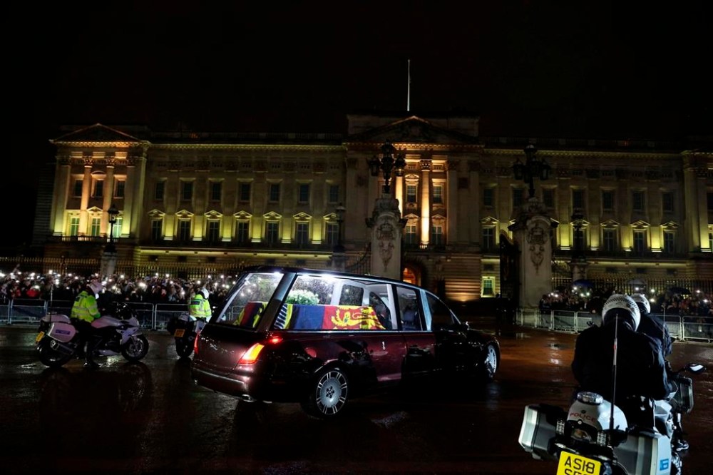 The hearse carrying the coffin of Queen Elizabeth II arrives at Buckingham Palace, London, Tuesday, Sept. 13, 2022, from where it will rest overnight in the Bow Room. (Paul Childs/Pool Photo via AP)