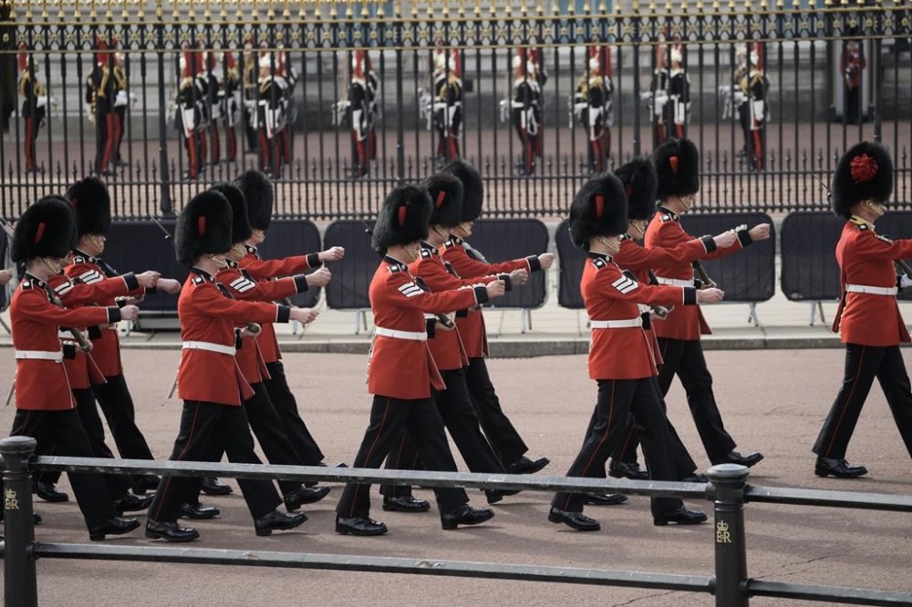 Grenadier Guards arrive at Buckingham Palace from where the coffin of late Queen Elizabeth II will depart in procession to Westminster Hall in London, Wednesday, Sept. 14, 2022. The Queen will lie in state in Westminster Hall for four full days before her funeral on Monday Sept. 19. (AP Photo/Vadim Ghirda, Pool)