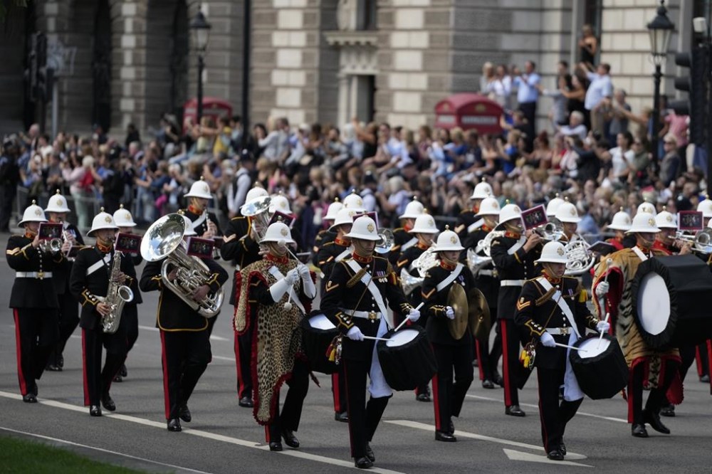 The band of the Royal marines perform ahead of the procession of the Gun Carriage which will carry the coffin of Queen Elizabeth II from Buckingham Palace to Westminster Hall in London, Wednesday, Sept. 14, 2022. The Queen will lie in state in Westminster Hall for four full days before her funeral on Monday Sept. 19. (AP Photo/Frank Augstein, Pool)