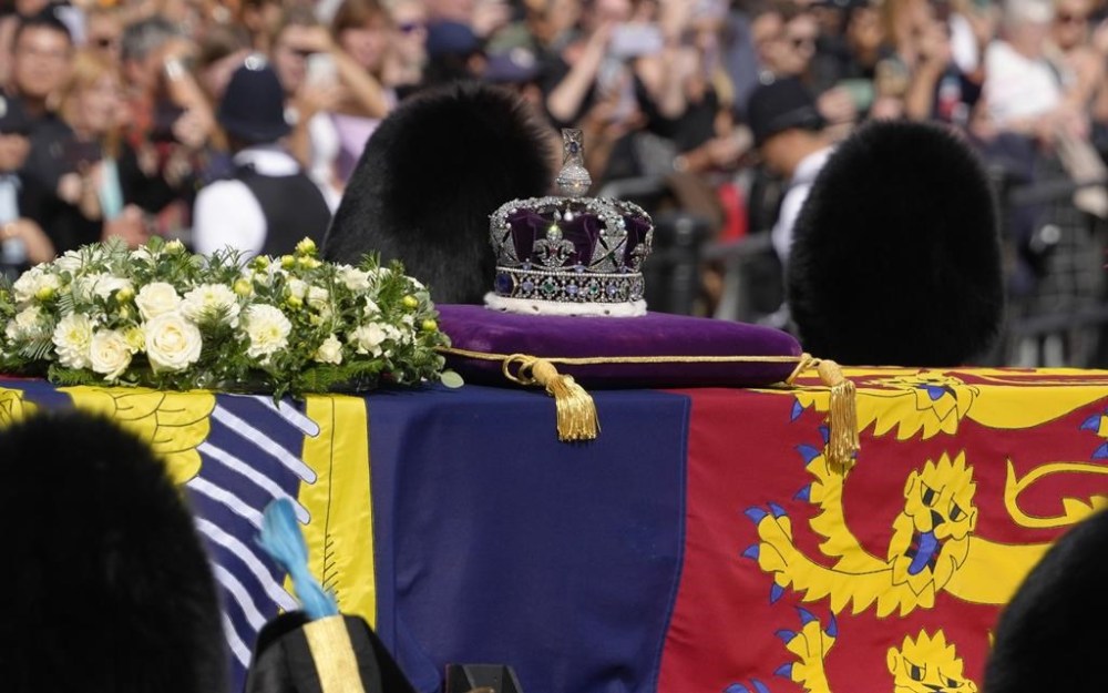 Grenadier Guards flank the coffin of Queen Elizabeth II during a procession from Buckingham Palace to Westminster Hall in London, Wednesday, Sept. 14, 2022. The Queen will lie in state in Westminster Hall for four full days before her funeral on Monday Sept. 19. (AP Photo/Kirsty Wigglesworth)