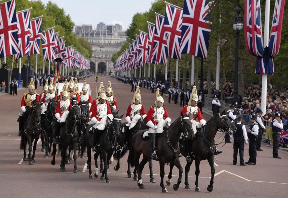 Mounted Household Cavalry ride along the route prior to the procession of the Gun Carriage which will carry the coffin of Queen Elizabeth II from Buckingham Palace to Westminster Hall in London, Wednesday, Sept. 14, 2022. The Queen will lie in state in Westminster Hall for four full days before her funeral on Monday Sept. 19. (AP Photo/Kirsty Wigglesworth)