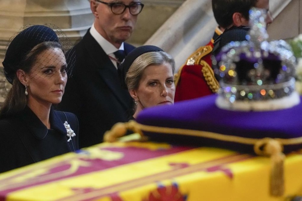 Britain's Kate, Princess of Wales, left, and Sophie, Countess of Wessex watch the coffin of Queen Elizabeth arrive in Westminster Hall, London, Wednesday, Sept. 14, 2022. The Queen will lie in state in Westminster Hall for four full days before her funeral on Monday Sept. 19. (AP Photo/Gregorio Borgia, Pool)