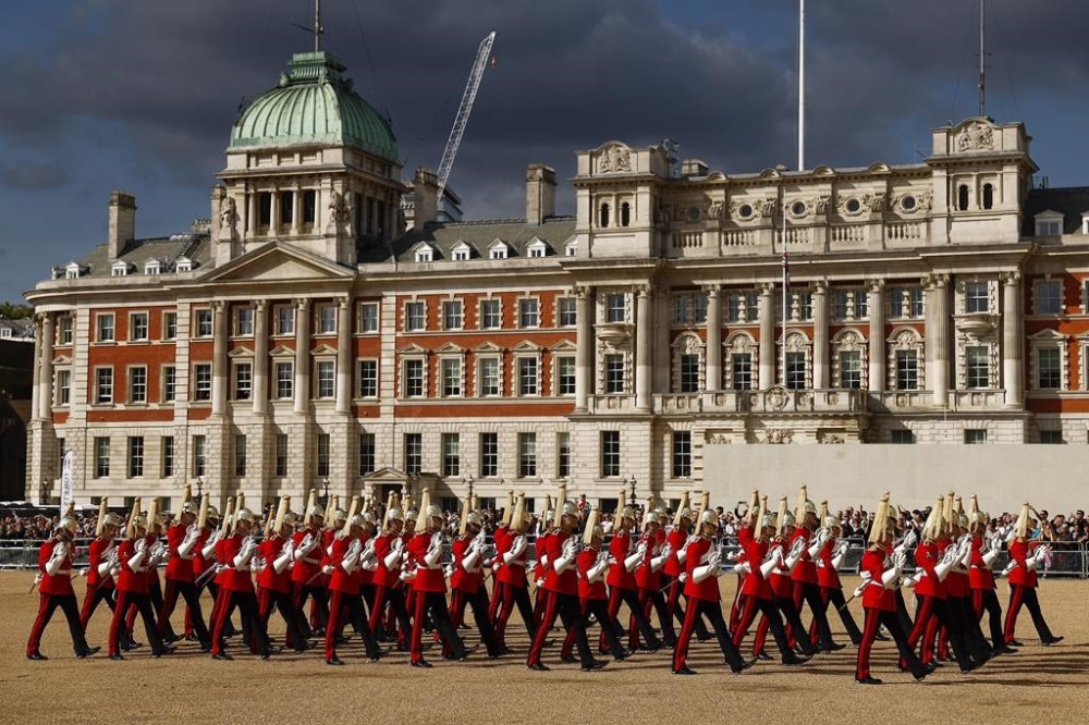 Royal guards march at Horse Guards Parade during the procession of the coffin of Queen Elizabeth II from Buckingham Palace to Westminster Hall, London, Wednesday Sept. 14, 2022. The Queen will lie in state in Westminster Hall for four full days before her funeral on Monday Sept. 19. ( Jeff J Mitchell/Pool via AP)