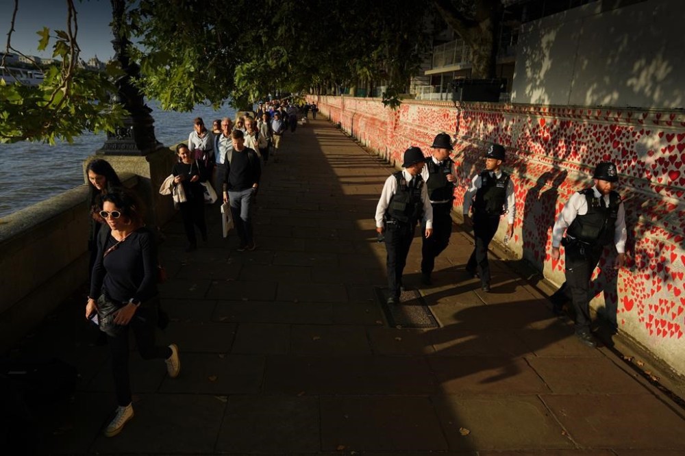 People queue to pay their respects to late Queen Elizabeth II who's body is lying in state at Westminster Hall in London, Wednesday, Sept. 14, 2022. The Queen will lie in state in Westminster Hall for four full days before her funeral on Monday Sept. 19. (AP Photo/Petr David Josek)