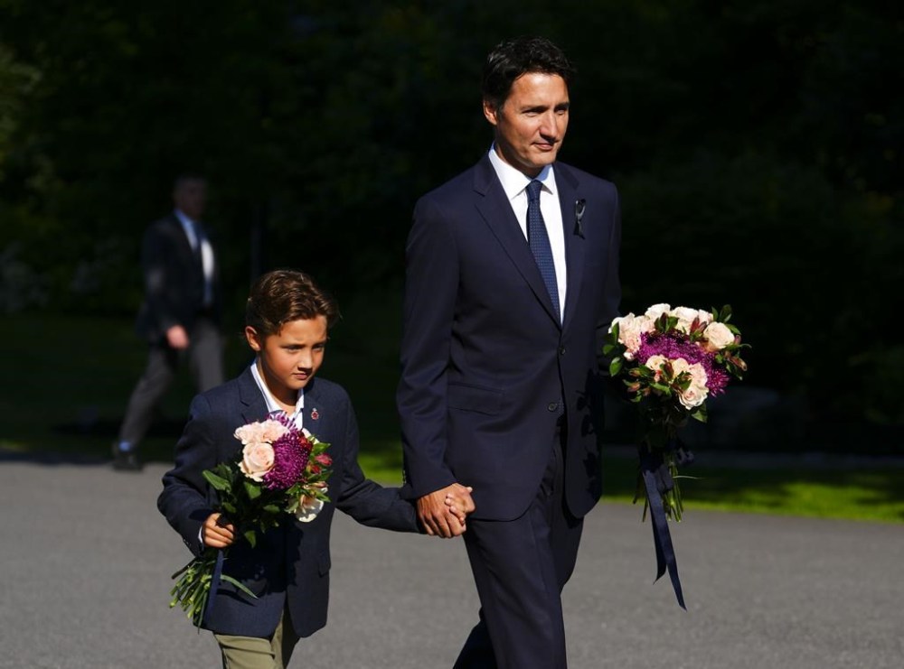 Prime Minister Justin Trudeau and son Hadrien arrive to place flowers for Queen Elizabeth II prior to a ceremony to proclaim the accession of the new Sovereign, King Charles III, at Rideau Hall, in Ottawa, Saturday, Sept. 10, 2022. Trudeau has declared Sept. 19 a federal holiday to mourn Queen Elizabeth II on the day of her state funeral in London. THE CANADIAN PRESS/Sean Kilpatrick