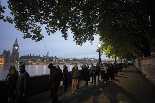 People queue to pay their respect to the late Queen Elizabeth II during the Lying-in State, at Westminster Hall in London, Thursday, Sept. 15, 2022. The Queen will lie in state in Westminster Hall for four full days before her funeral on Monday Sept. 19. (AP Photo/Markus Schreiber)