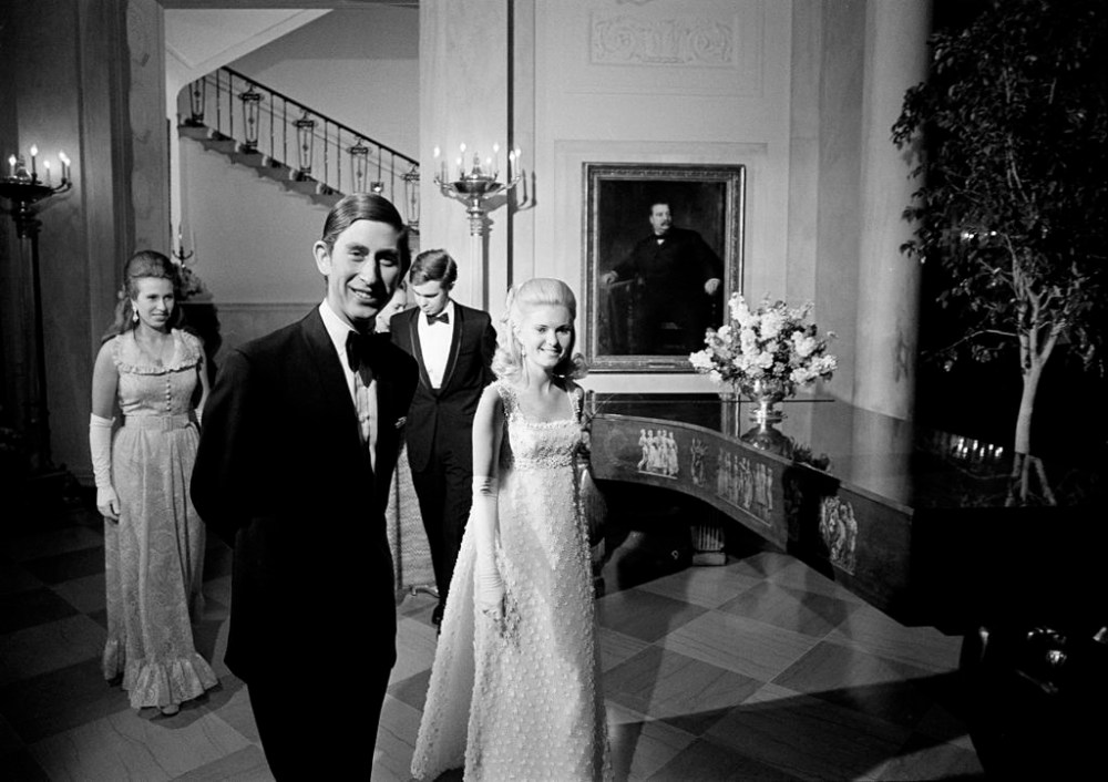 FILE - Prince Charles and Tricia Nixon lead the way to join guests at a White House supper-dance, July 17, 1970. Following are Princess Anne, left, and Julie Nixon, hidden, and David Eisenhower. (AP Photo, File)