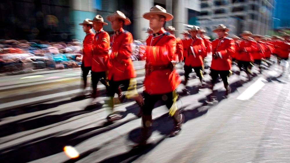 Members of the Royal Canadian Mounted Police march during the Calgary Stampede parade in Calgary, Friday, July 6, 2012. Members of the military and RCMP will parade through the streets of Ottawa at 12:10 p.m., in tribute to Queen Elizabeth, and sound a 96-gun salute -- one salvo for every year of the queen's life. THE CANADIAN PRESS/Jeff McIntosh
