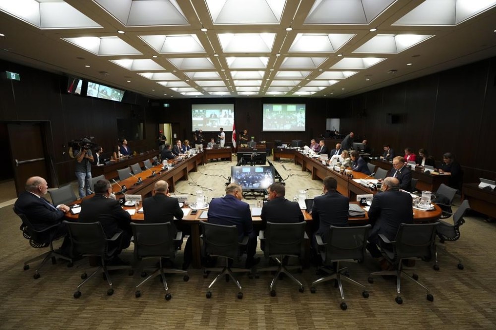 Witnesses Scott Smith, Hockey Canada President and Chief Operating Officer, middle right, and Hockey Canada Chief Financial Officer Brian Cairo, middle left, join fellow witnesses as they appear at the standing committee on Canadian Heritage in Ottawa on Wednesday, July 27, 2022. The House of Commons heritage committee has ordered another round of hearings into the Hockey Canada's handling of sexual assault claims, with past and present top executives and board chairs summoned to testify. THE CANADIAN PRESS/Sean Kilpatrick