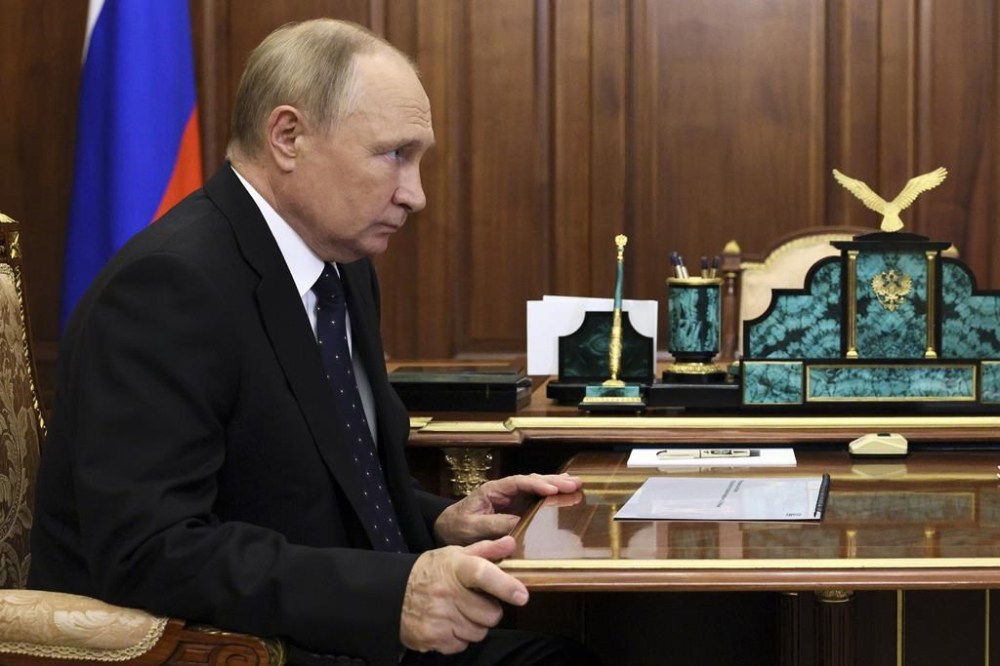 Russian President Vladimir Putin listens to Vitaly Mutko, the chief executive officer of Dom.RF, a state-owned company involved in the mortgage and realty market during their meeting at the Kremlin in Moscow, Russia. v in Moscow, Russia, Thursday, Sept. 22, 2022. (Gavriil Grigorov, Sputnik, Kremlin Pool Photo via AP)