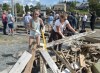 Madelyn Watts, left, and Angelina Taylor clean up debris on the government wharf as Ralph Goodale, minister of Public Safety and Emergency Preparedness and Harjit Sajjan, minister of National Defence, hold a news conference in the background in Herring Cove, N.S. on Tuesday, Sept. 10, 2019. Hurricane Dorian brought wind, rain and heavy seas that knocked out power across the region. THE CANADIAN PRESS/Andrew Vaughan