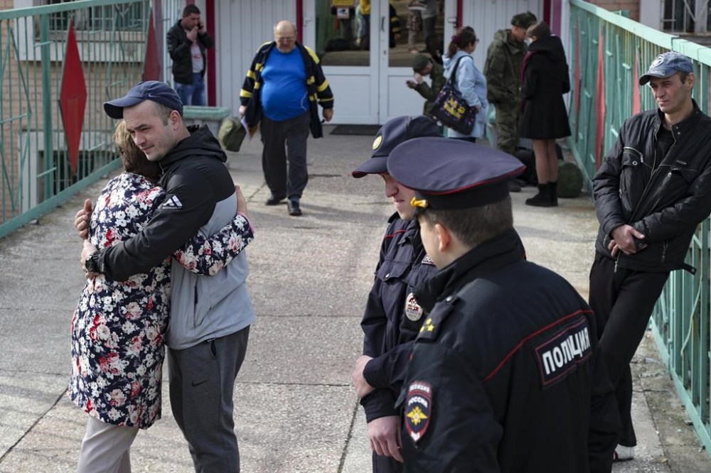 A Russian recruit hugs his mother at a military recruitment center in Volgograd, Russia, Saturday, Sept. 24, 2022. Russian President Vladimir Putin on Wednesday ordered a partial mobilization of reservists to beef up his forces in Ukraine. (AP Photo)