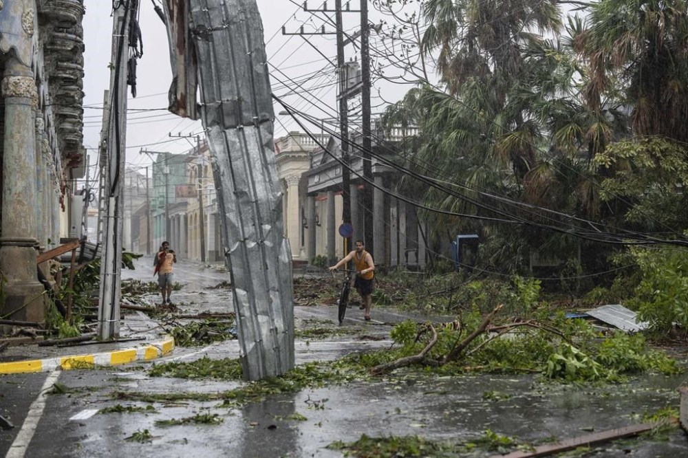 Fallen electricity lines, metal and tree branches litter a street after Hurricane Ian hit Pinar del Rio, Cuba, Tuesday, Sept. 27, 2022. Ian made landfall at 4:30 a.m. EDT Tuesday in Cuba’s Pinar del Rio province, where officials set up shelters, evacuated people, rushed in emergency personnel and took steps to protect crops in the nation’s main tobacco-growing region. (AP Photo/Ramon Espinosa)