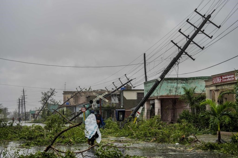 Fallen utility poles and fallen branches line a street after Hurricane Ian hit Pinar del Rio, Cuba, Tuesday, Sept. 27, 2022. Ian made landfall at 4:30 a.m. EDT Tuesday in Cuba’s Pinar del Rio province, where officials set up shelters, evacuated people, rushed in emergency personnel and took steps to protect crops in the nation’s main tobacco-growing region. (AP Photo/Ramon Espinosa)