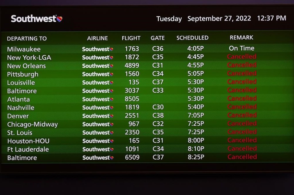 Canceled flights are shown on a video board at the Southwest Airlines ticket counter at the Tampa International Airport Tuesday, Sept. 27, 2022, in Tampa, Fla. The airport is closing at 5pm EST today ahead of a planned landfall by Hurricane Ian. Ian is predicted to make landfall somewhere along Florida's west coast. (AP Photo/Chris O'Meara)