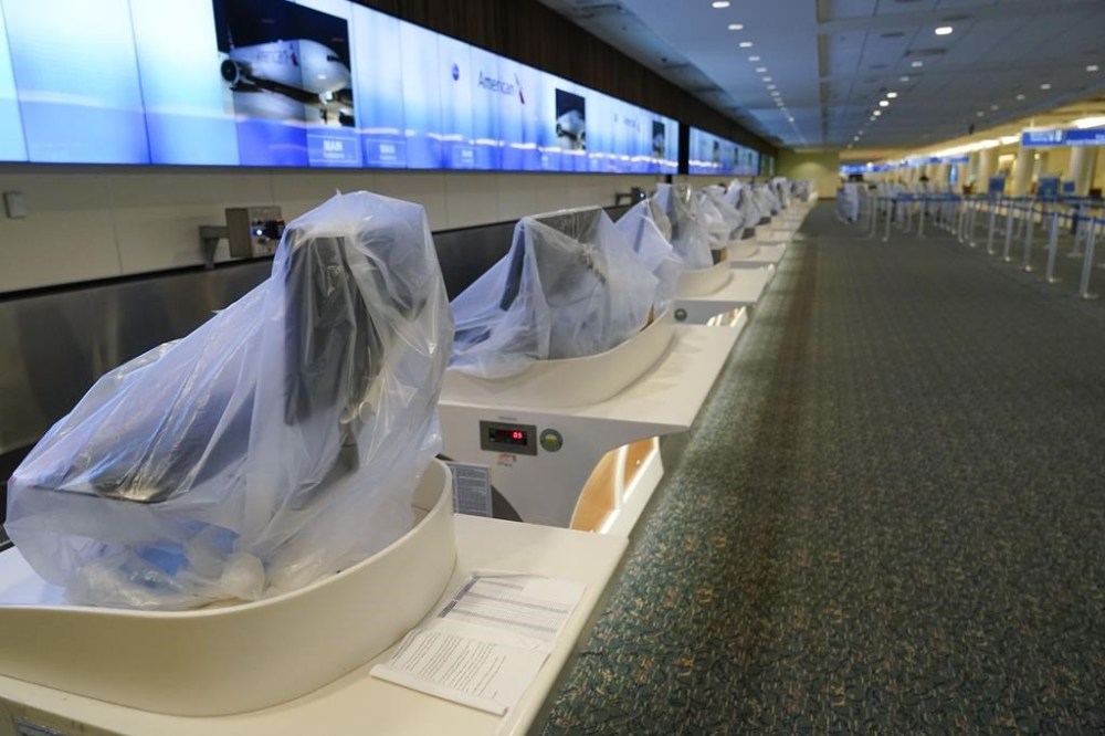 American Airlines check-in counters are closed at Orlando International Airport ahead of Hurricane Ian, Wednesday, Sept. 28, 2022, in Orlando, Fla. (AP Photo/John Raoux)