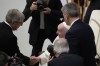 Thomas Bach, President of the International Olympic Committee, left, greets Pope Francis during an audience the Pontiff granted to the participants of the 