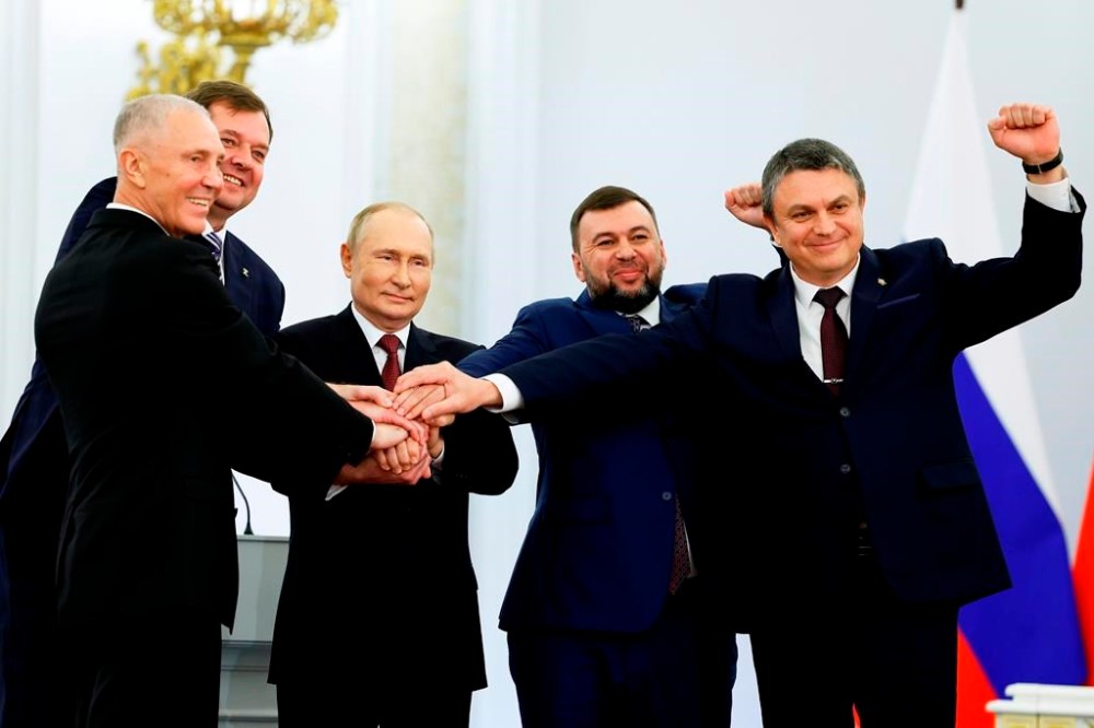 From left, Moscow-appointed head of Kherson Region Vladimir Saldo, Moscow-appointed head of Zaporizhzhia region Yevgeny Balitsky, Russian President Vladimir Putin, Denis Pushilin, leader of self-proclaimed Donetsk People's Republic and Leonid Pasechnik, leader of self-proclaimed Luhansk People's Republic pose for a photo during a ceremony to sign the treaties for four regions of Ukraine to join Russia, at the Kremlin in Moscow, Friday, Sept. 30, 2022. The signing of the treaties making the four regions part of Russia follows the completion of the Kremlin-orchestrated