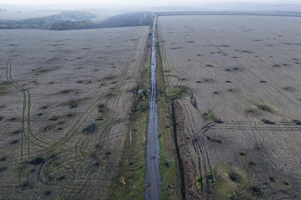 Artillery craters are seen in the field from an arial view in the recently liberated area of Kharkiv region, Ukraine, Friday, Sept. 30, 2022. (AP Photo/Evgeniy Maloletka)