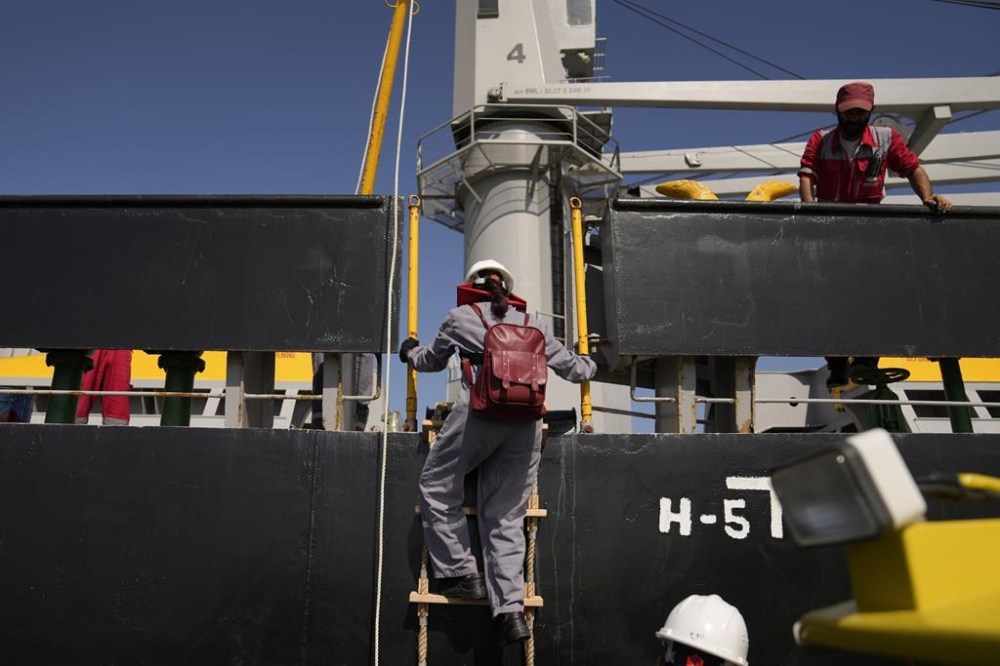 U.N. officials arrive to the cargo ship Med Island, which came from Ukraine loaded with grain, for inspection while it is anchored in the Marmara Sea in Istanbul, Turkey, Saturday, Oct. 1, 2022. (AP Photo/Khalil Hamra)
