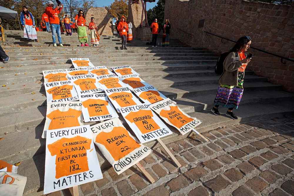Signs laid out on the steps of the Oodena Celebration Circle Friday at The Forks on the National Day of Truth and Reconciliation. (Mike Deal / Winnipeg Free Press)