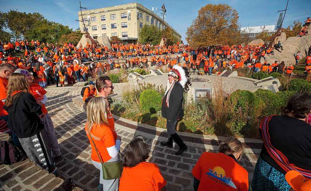 Manitoba Keewatinowi Okimakanak Grand Chief Garrison Settee walks through the crowd as people gather for a ceremony at the Oodena Celebration Circle Friday morning at The Forks. (Mike Deal / Winnipeg Free Press)