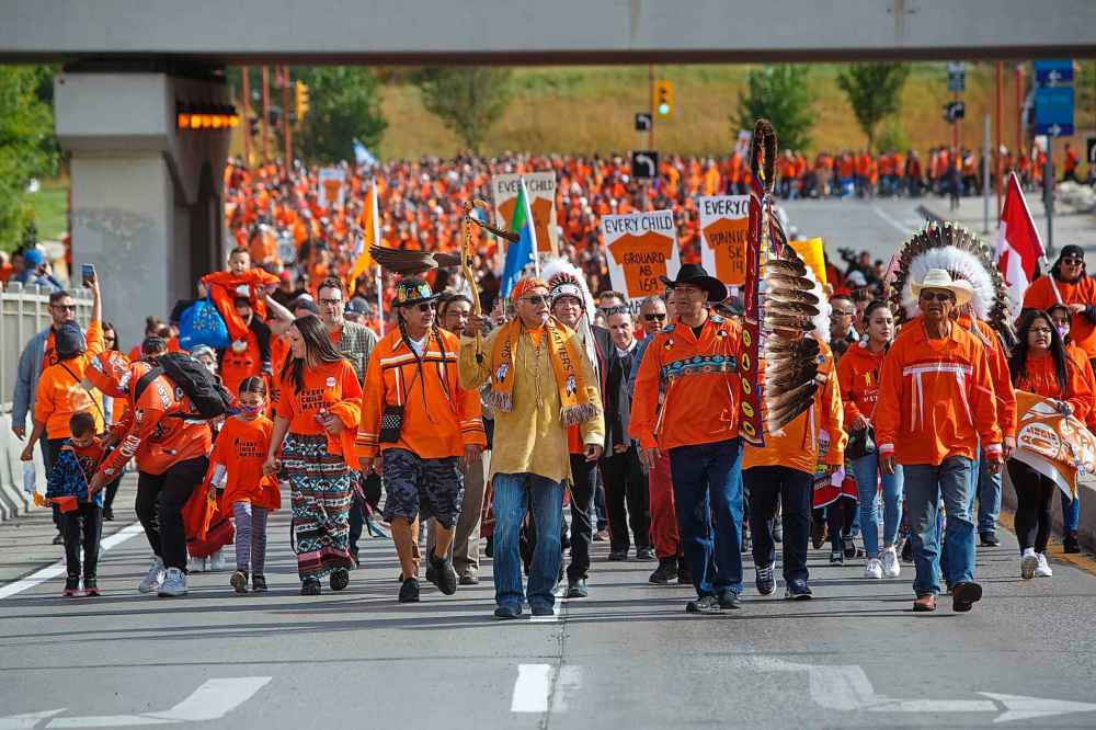 Hundreds of people take part in the march towards the convention centre from The Forks Friday morning. (Mike Deal / Winnipeg Free Press)