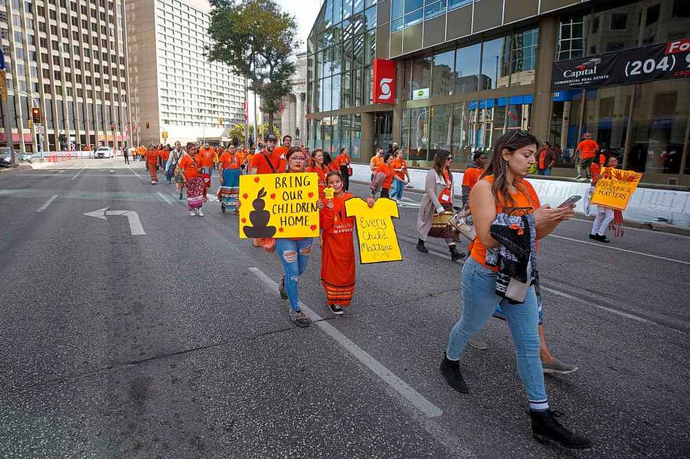 Hundreds of people of all ages took park in the march from The Forks to the convention centre. (Mike Deal / Winnipeg Free Press)