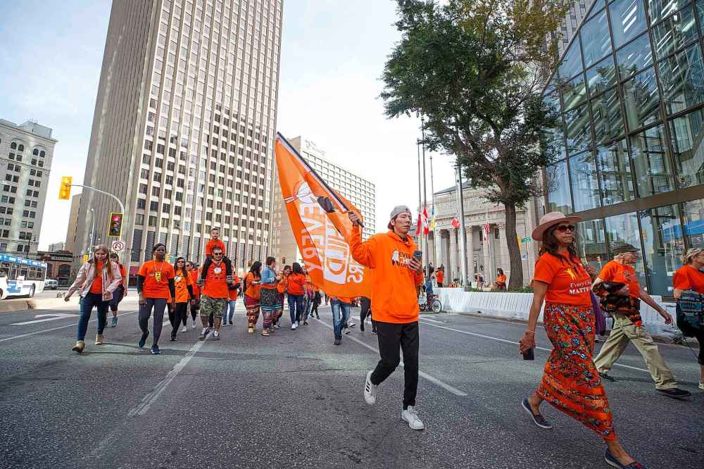 The march from The Forks to the convention centre included hundreds of people. (Mike Deal / Winnipeg Free Press)