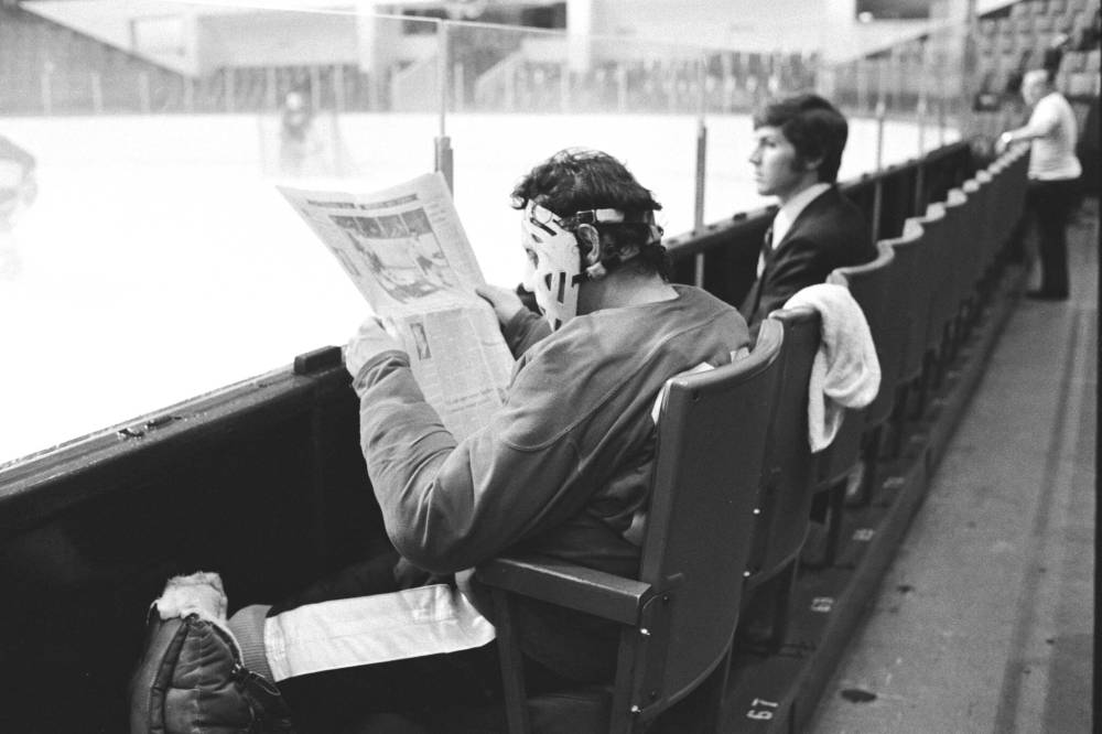 ANDY CLARK / THE CANADIAN PRESS FILES
Netminder Tony Esposito reads a newspaper with his mask on during a Team Canada practice ahead of the 1972 Summit Series in Toronto, on Aug. 23, 1972.