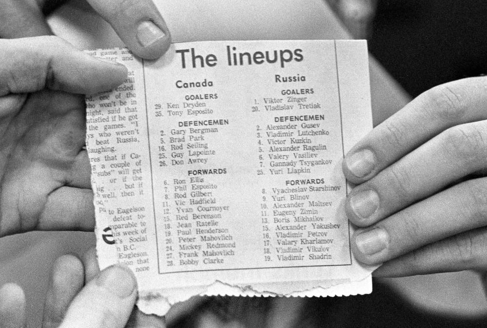 PETER BREGG / THE CANADIAN PRESS FILES
Members of the media hold up the lineup sheet listing the Canadian and USSR players in advance of Game 1 in Montreal.